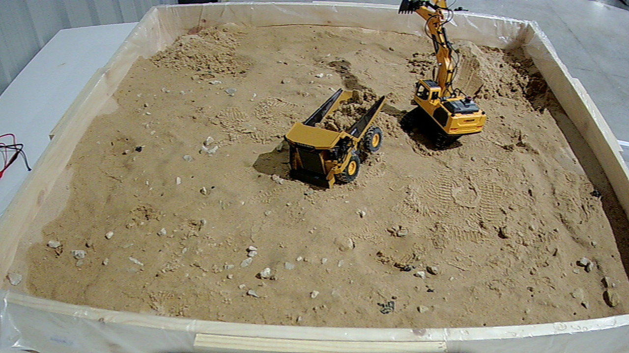 Excavator and dumptruck in the indoor sand tray
